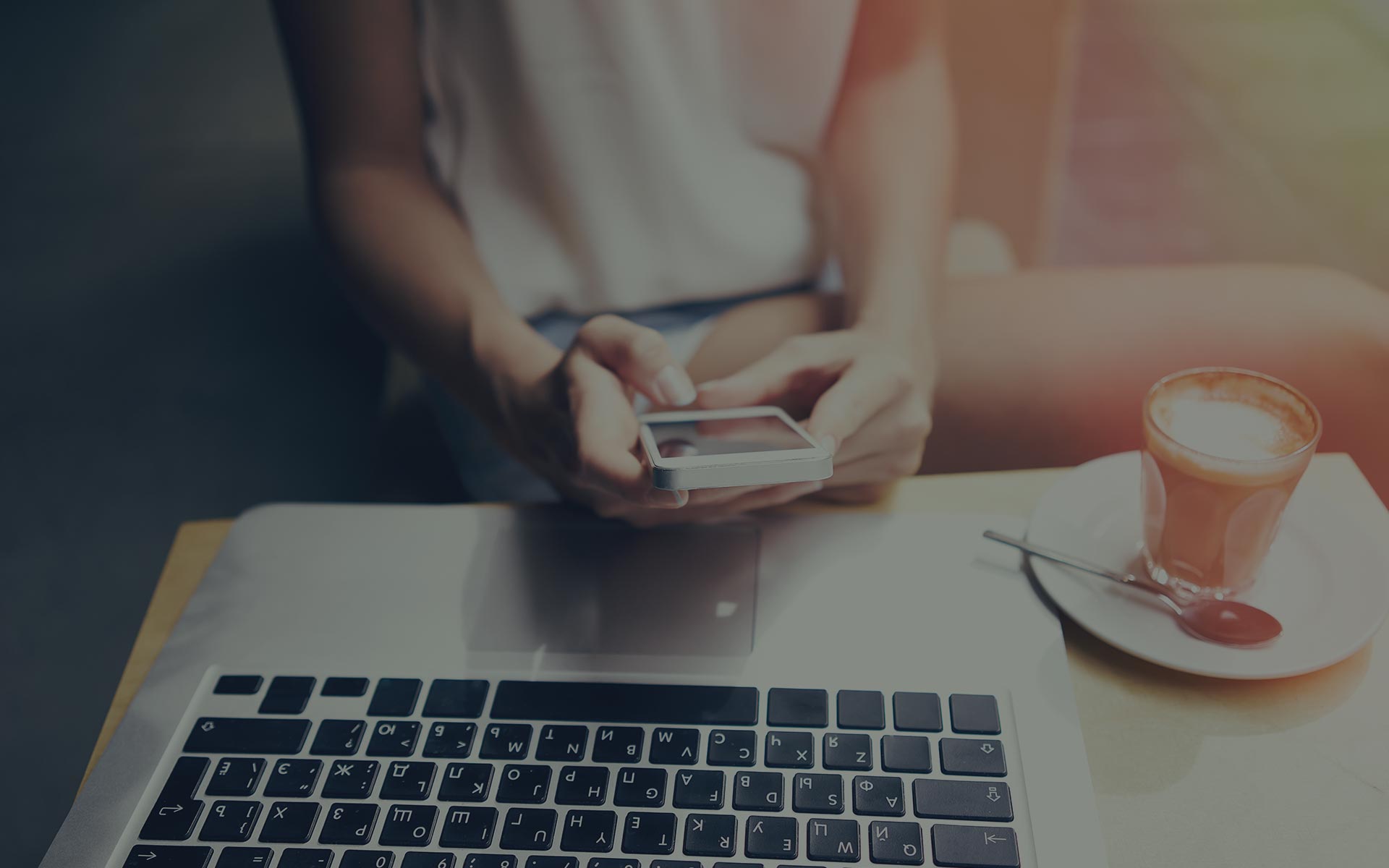 A laptop and phone on a table, ready for a business conversation